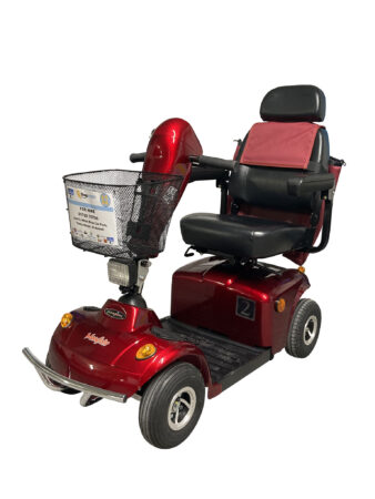 Shiny metallic-red, mobility scooter with a wire basket and black padded leather seat and head-rest with matching arm-rests.